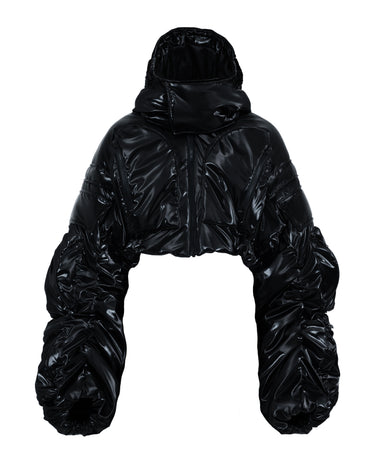 Black cropped puffer jacket with hood, shiny quilted texture and voluminous sleeves