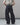 Dark navy wide-leg jeans with front crease, belt loops, and contrast orange stitching