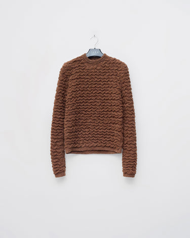 Brown cable-knit sweater with crew neck and long sleeves