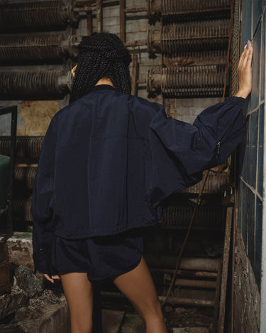 Navy micro shorts with elastic waistband, relaxed fit, back view
