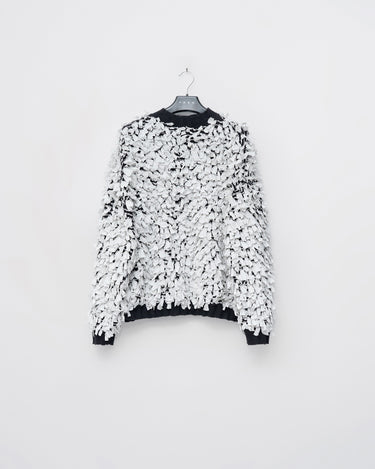 Ivory shred sweater with black flecks, crew neck, long fringed sleeves, textured knit