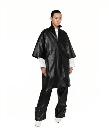 Dark short-sleeve anorak jacket with half-zip front and flap patch pockets, side view