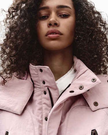 Pink hooded nylon jacket with buttoned collar and zippered chest pocket detail