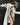 White long balmacaan coat with button front and notched collar, side view