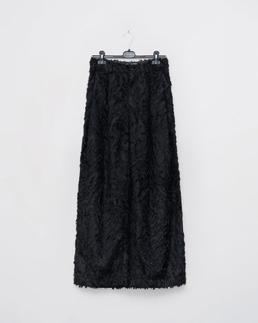 Black fringed texture trousers hanging, shown from the front.