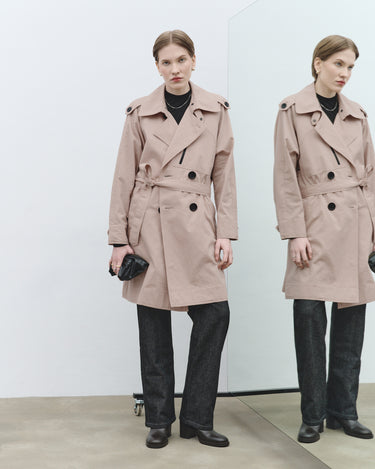 Nude textured trench coat front view with belt, black buttons, and notched collar.