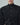 Black tuxedo vest shirt with a high collar, pleated bib, buttons, and wraparound waist tie