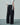 Black fringed texture trousers with a wide-leg cut and full-length hems.