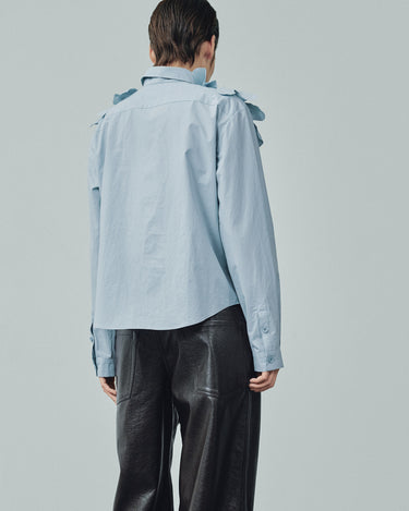 Light blue button-up shirt, back view, petal ruffle shoulder detail