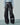 Black loose-fit faux leather pants with wide legs and stitched panel seams
