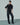 Black button-up shirt with petal ruffle shoulders, pointed collar and long sleeves, on model
