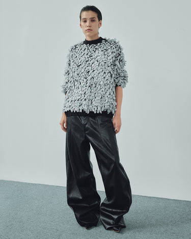 Ivory shredded sweater with crew neck and long fringed sleeves, layered textured fabric