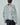 Back view of ivory shredded sweater with crew neck and long fringed layered texture