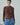 Brown cable-knit sweater with textured cable pattern at the front