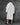 White long balmacaan coat with back yoke and buttoned cuffs, rear angle