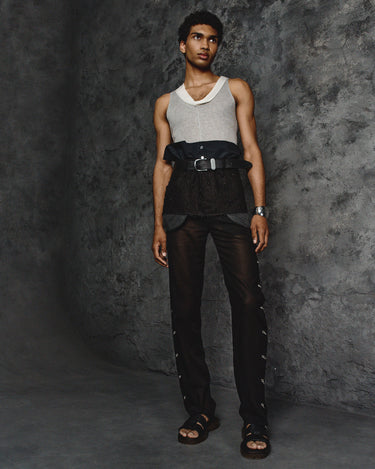 Black waist apron with wide belt buckle and layered utility pockets over denim-style bib