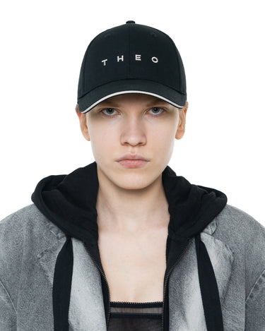 Black baseball cap with white THEO lettering, front view