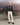 Black balloon jacket with front zip, chest pockets, and gathered cuffs