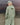 Light green wind shell jacket from back view with adjustable hood and elastic hem