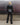 Men's black faux-leather trousers, back view with stitched seams and straight legs