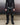 Men's black faux-leather trousers front view with belt loops and zip fly