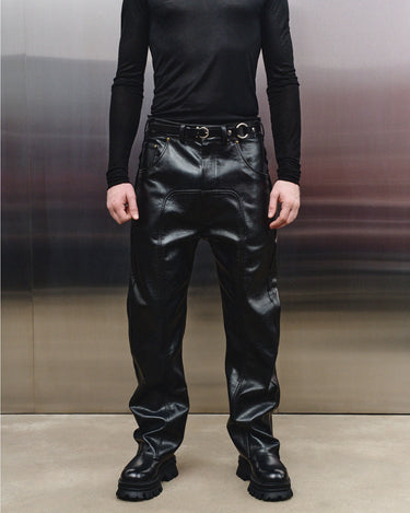 Men's black faux-leather trousers front view with belt loops and zip fly
