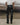 Black leather-look ugly trousers with belt loops and glossy tapered legs