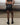 Black faux-leather mini shorts with elastic waistband and side stitching