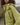 Green nylon TMBY jacket close-up with drawcord hood and zip pocket