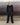 Black track pants with elastic waistband and relaxed straight legs, back view