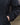Dark wind shell jacket sleeve cuff and pocket seam detail, relaxed fit