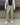 Light green track pants front view with elastic waistband and relaxed straight legs