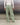 Light green track pants with elastic waistband and loose, cuffed legs