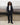 Black track pants with relaxed leg and elastic cuffs, worn with boots