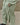 Light green track pants close-up of fabric seams and elastic ankle cuff