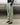 Light green track pants from the side, elastic waistband and cuffed ankle hems