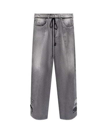 Distressed baggy jeans, light gray denim with front drawstring tie and patchy knee rips
