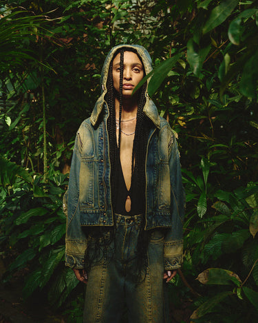 Faded denim jacket with hood up and large chest flap pockets