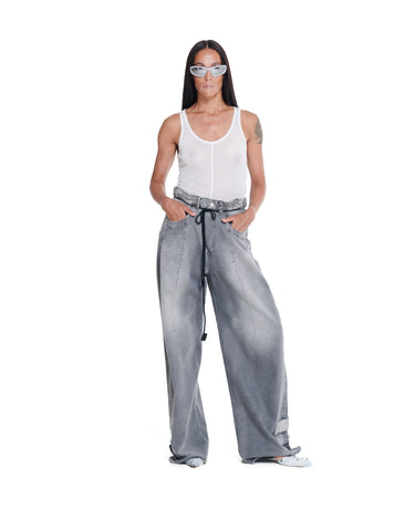 Distressed baggy jeans with wide-leg fit, light gray wash, and front drawstring tie