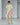 White lace dress with sheer overlay, neon-lime embroidered pattern, cape sleeves