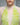 White lace dress neckline detail with neon-lime floral embroidery and tie keyhole