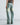 Light blue six-pocket jeans with distressed side rips and wide straight legs