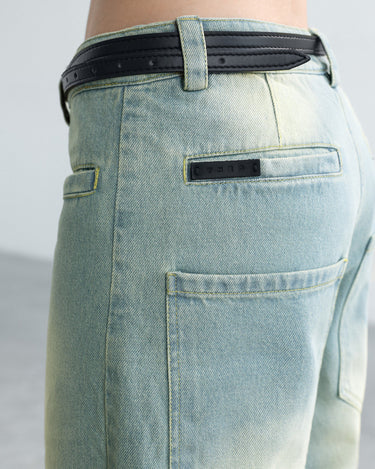 Light blue six-pocket jeans close-up: black belt, back pockets, stitched seams