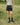 Black faux-leather mini shorts worn outdoors with drawstring waist