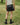 Black faux-leather mini shorts outdoors with elastic waist and front panel