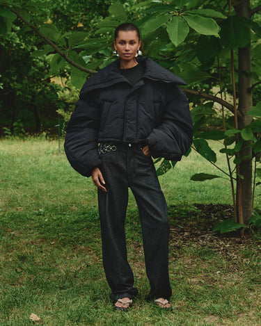 Black puffer winter jacket with turn-down collar, dropped shoulders, snap front