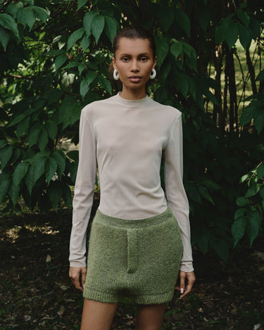 Nude sheer long-sleeve turtleneck top with clean crew-style neck