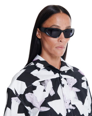 Black-and-white printed camp shirt with short sleeves and button front.
