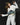 White denim-illusion apron with blue frayed waist panel, black belt and layered apron ties