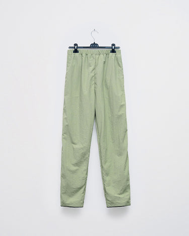 Light green track pants with elastic waistband, drawstring, and tapered legs